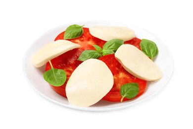 Plate of delicious Caprese salad with tomatoes, mozzarella and basil isolated on white