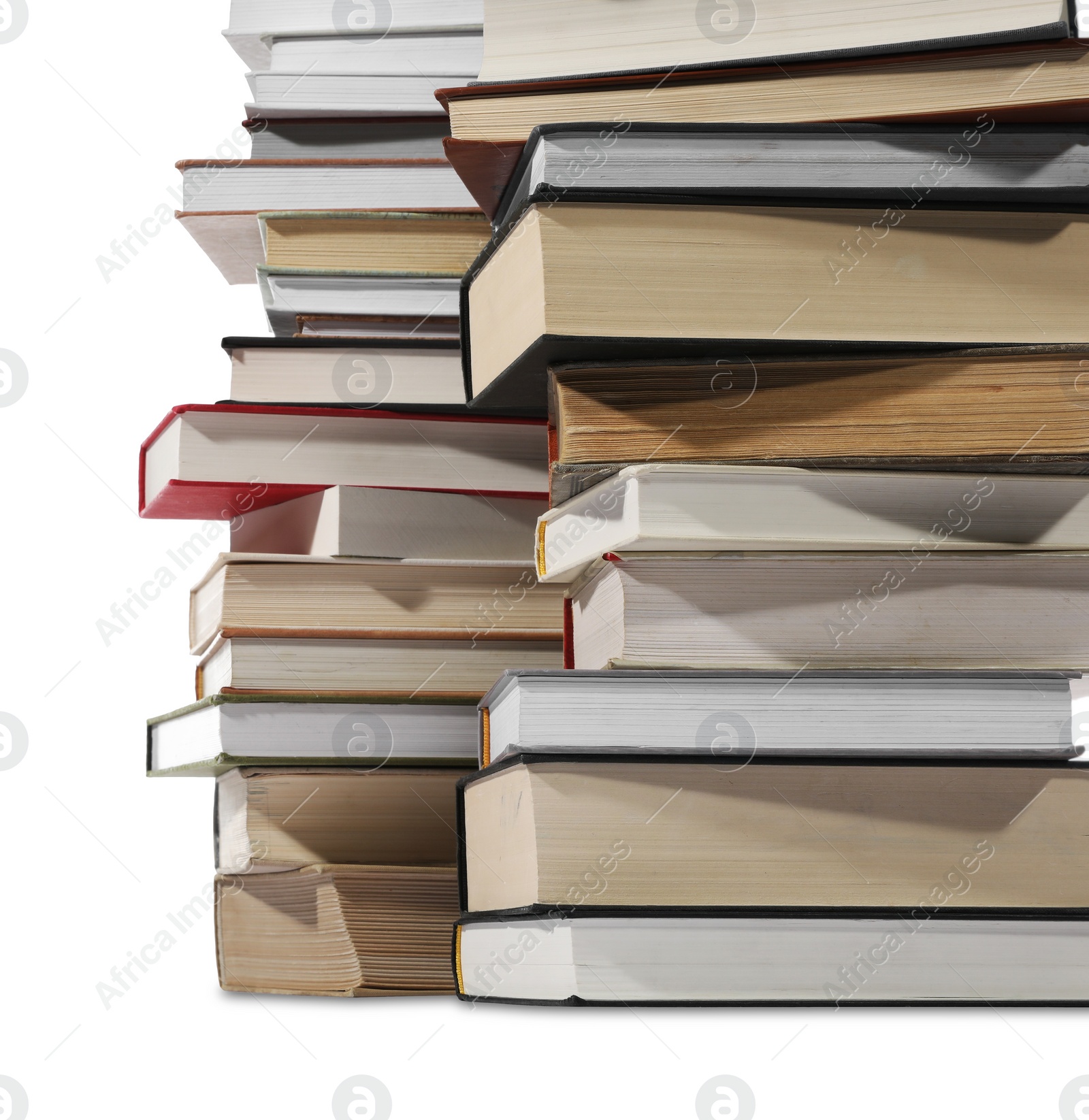 Photo of Stacks of many different books isolated on white