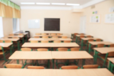 Photo of Blurred view of empty modern classroom at school