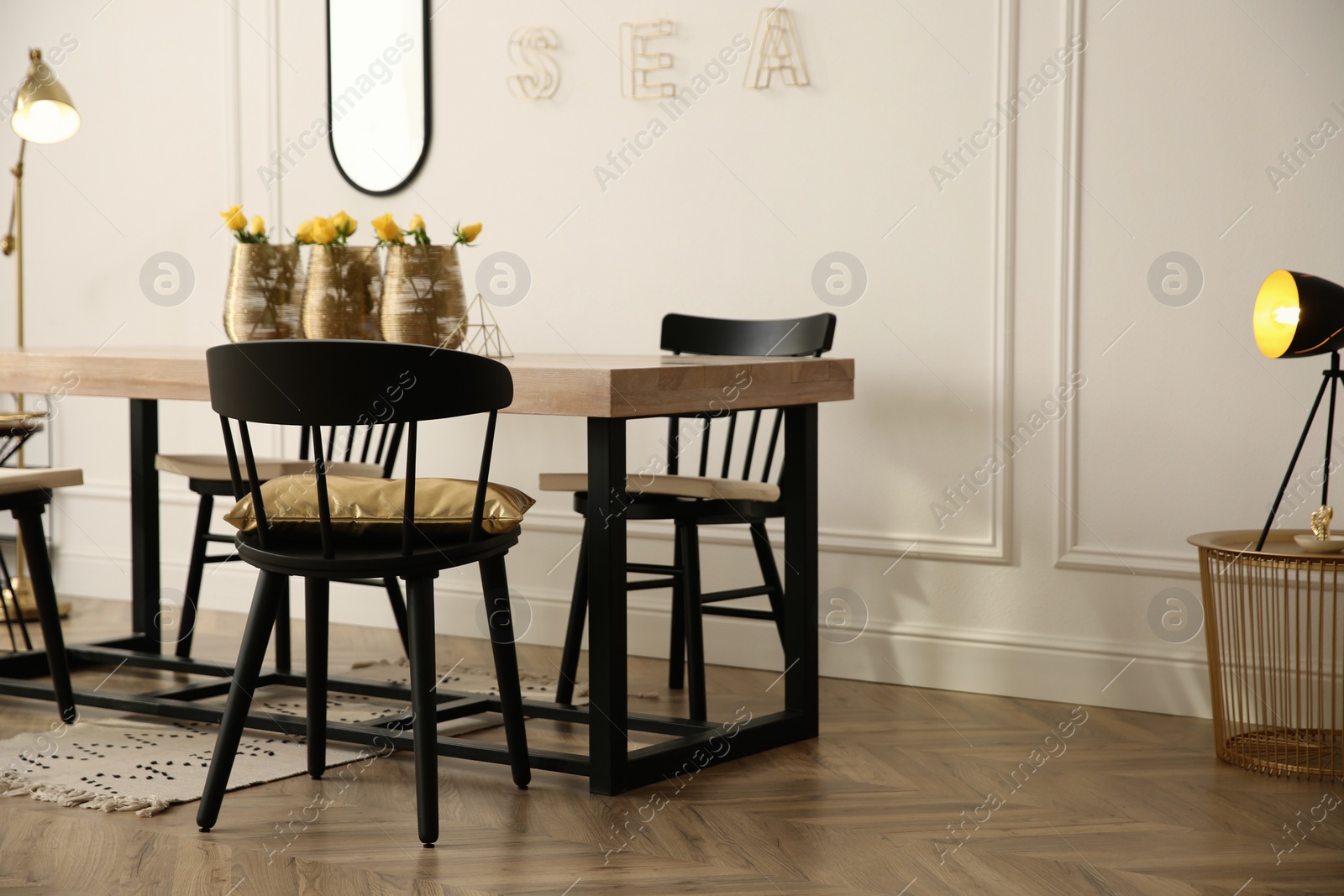 Photo of Stylish wooden dining table and chairs in room. Interior design