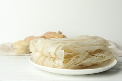 Raw rice noodles on white wooden table