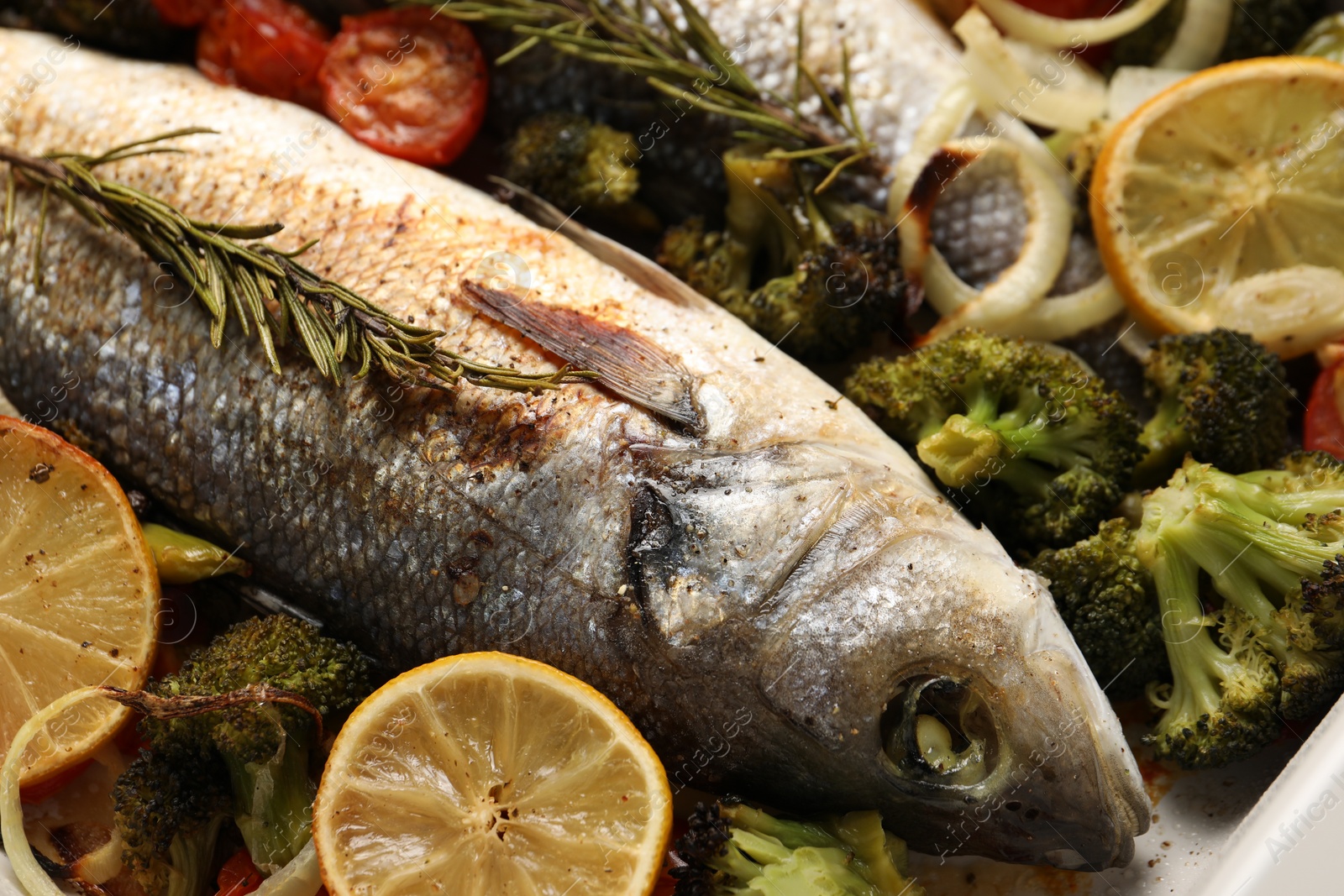 Photo of Delicious fish with vegetables and lemon, closeup