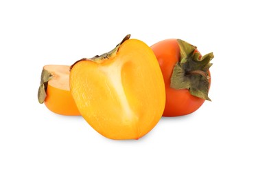 Photo of Whole and cut delicious ripe juicy persimmons on white background