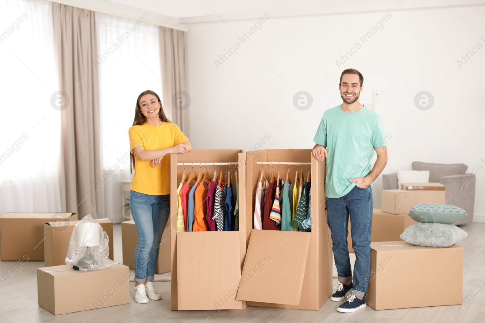 Photo of Young couple near wardrobe boxes at home