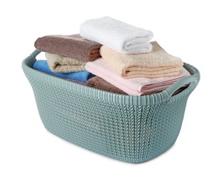 Photo of Plastic laundry basket with clean terry towels isolated on white