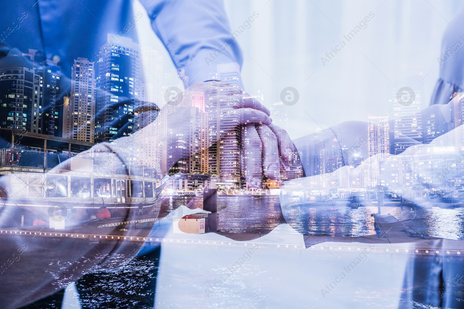Image of Partnership, cooperation, collaboration. Double exposure of night cityscape and people joining hands