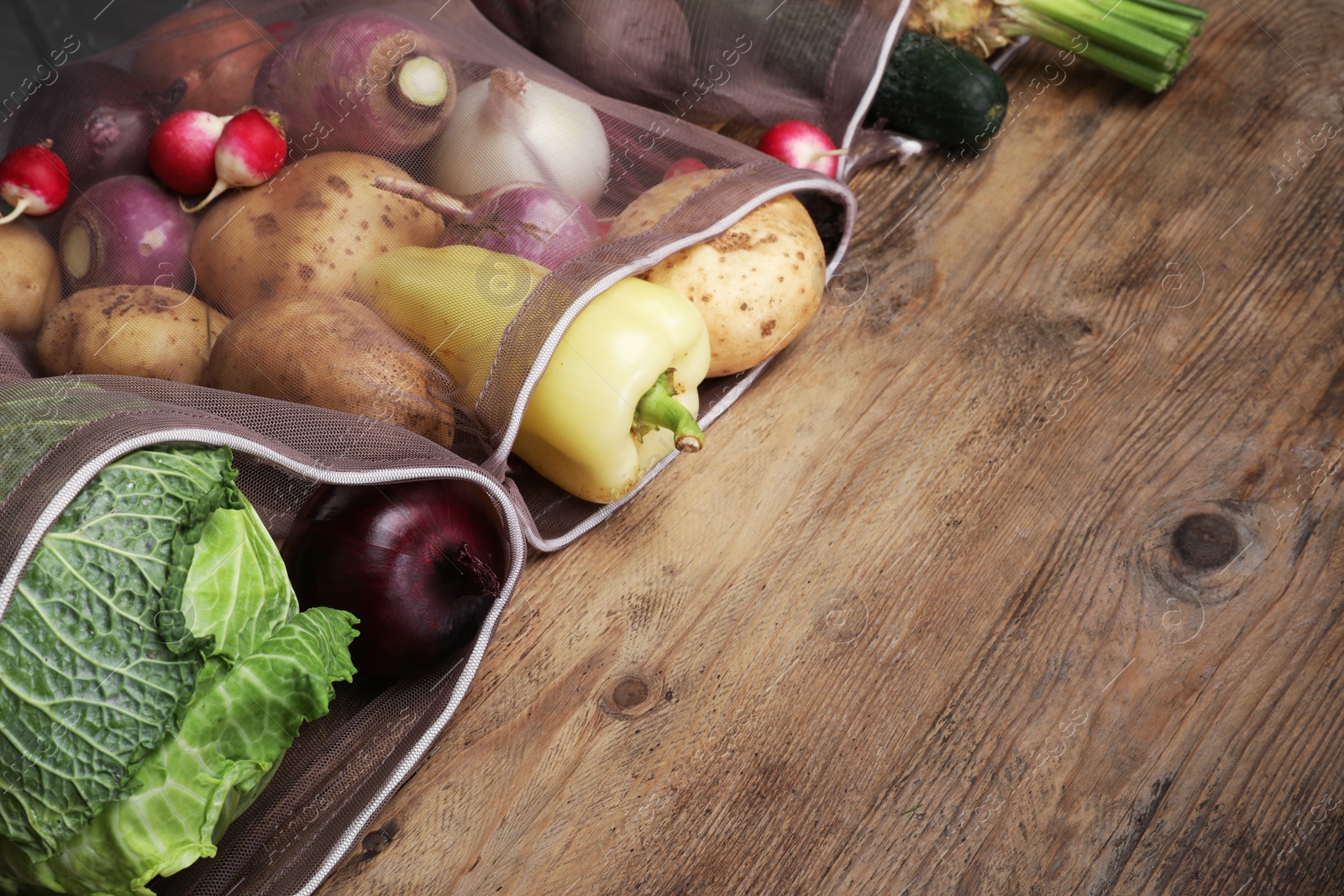 Photo of Different fresh ripe vegetables on wooden table. Space for text