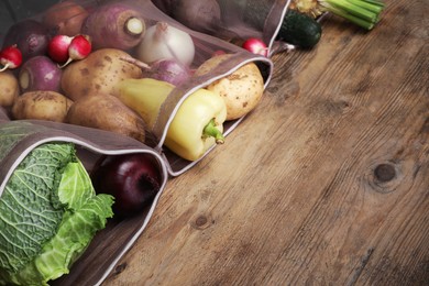 Photo of Different fresh ripe vegetables on wooden table. Space for text