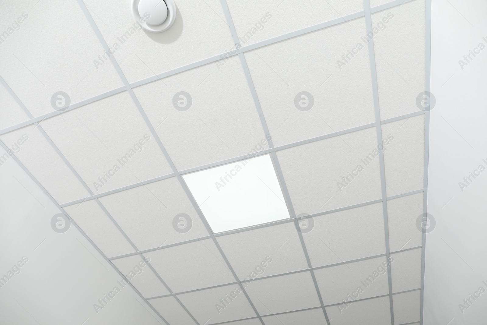 Photo of White ceiling with modern lighting in office