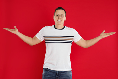 Happy handsome young man on red background