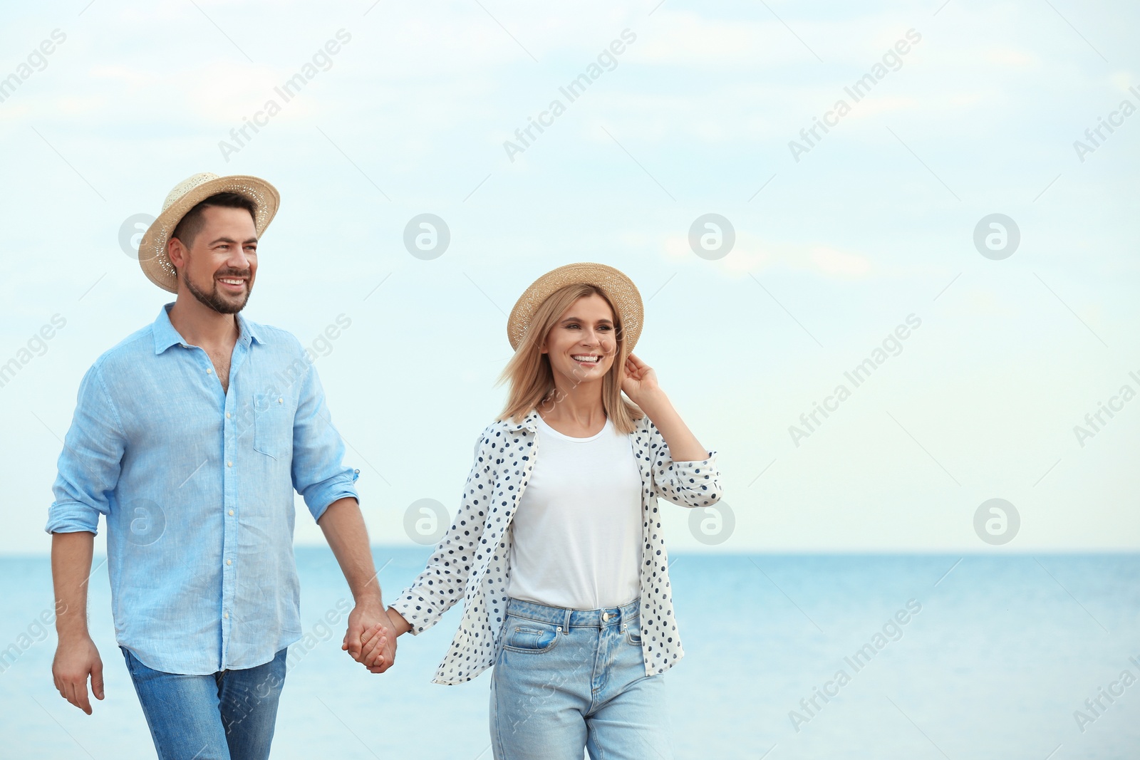 Photo of Happy romantic couple walking on beach, space for text