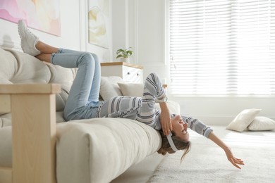 Young woman listening to music at home