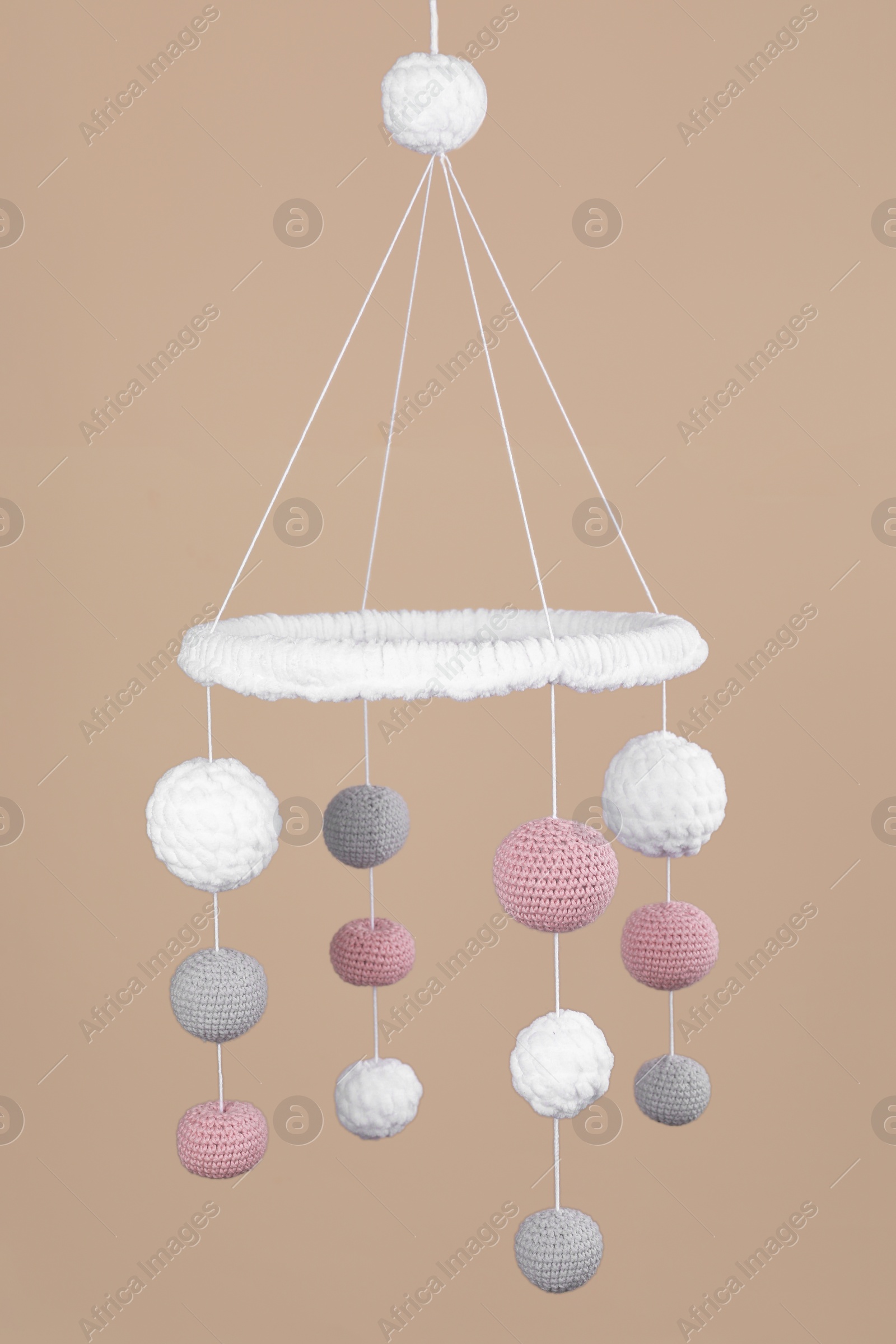 Photo of Cute baby crib mobile on beige background