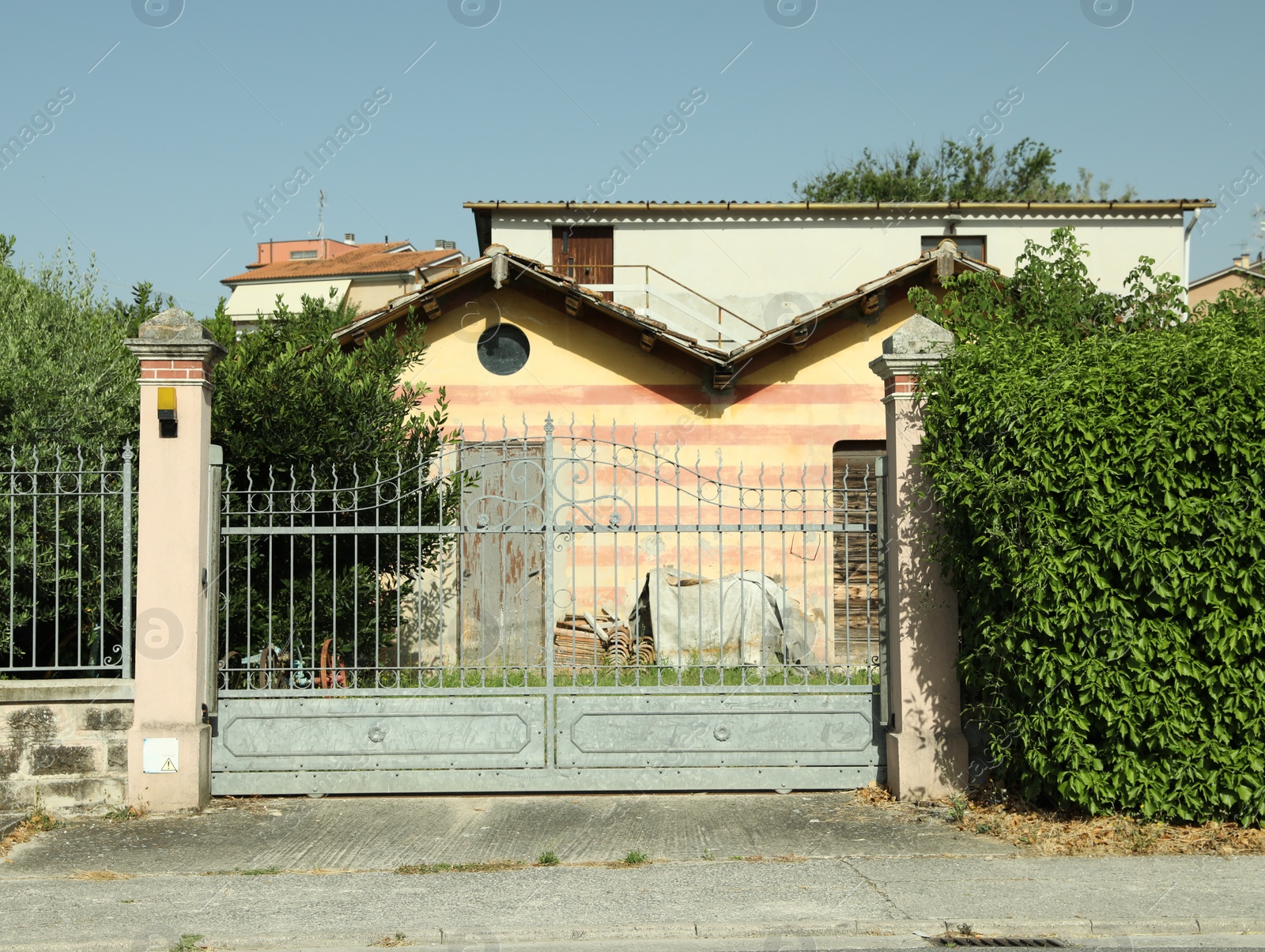 Photo of Beautiful gates and residential building on sunny day