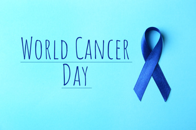 Image of Blue ribbon on color background, top view. World Cancer Day