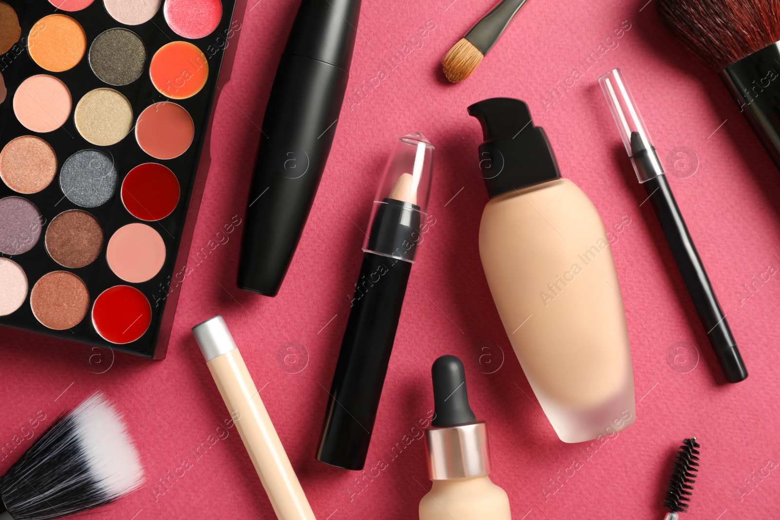 Photo of Set of makeup products on pink background, flat lay
