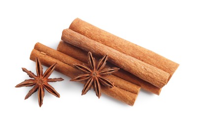 Aromatic cinnamon sticks and anise stars isolated on white, top view