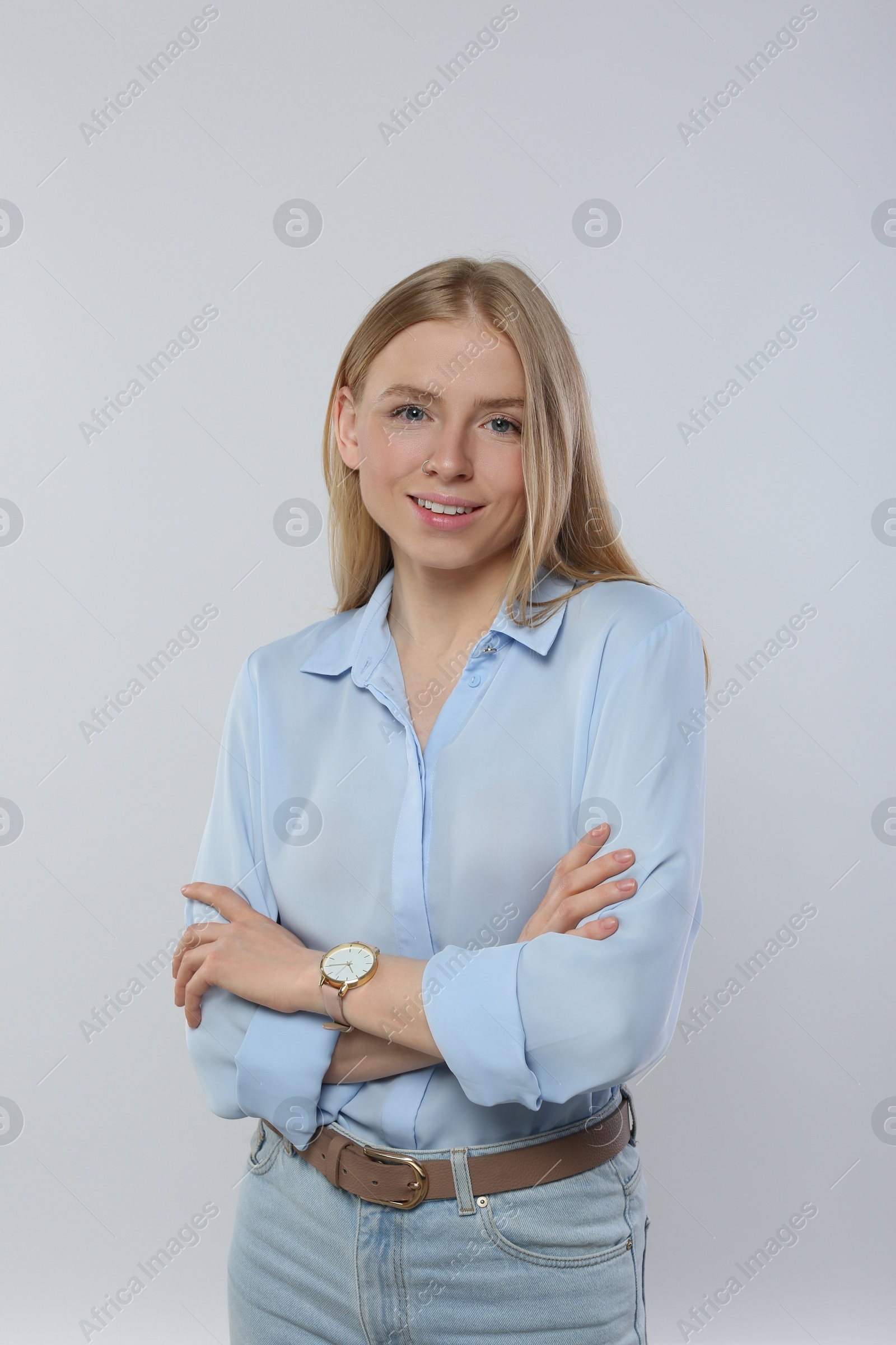 Photo of Portrait of beautiful young woman in stylish blouse on white background