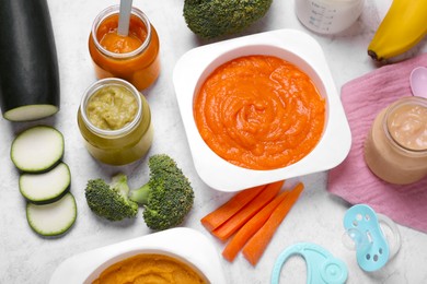 Photo of Composition with healthy baby food on white textured table, above view