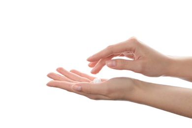Photo of Woman applying hand cream on white background, closeup