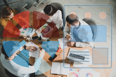 Image of Team of professional designers working together at table and colorful graphs illustration. Double exposure