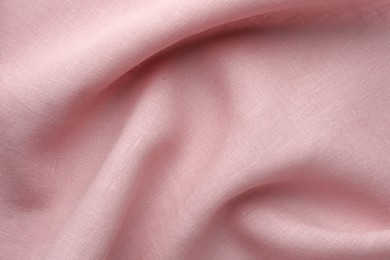 Photo of Texture of pink crumpled fabric as background, top view