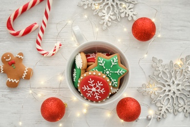 Photo of Cup with tasty homemade Christmas cookies on table, top view