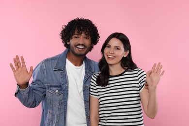 International dating. Portrait of happy couple on pink background