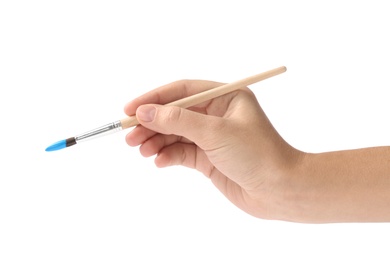 Photo of Young woman holding brush with color paint on white background, closeup