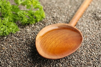Spoon with chia oil on seeds, closeup