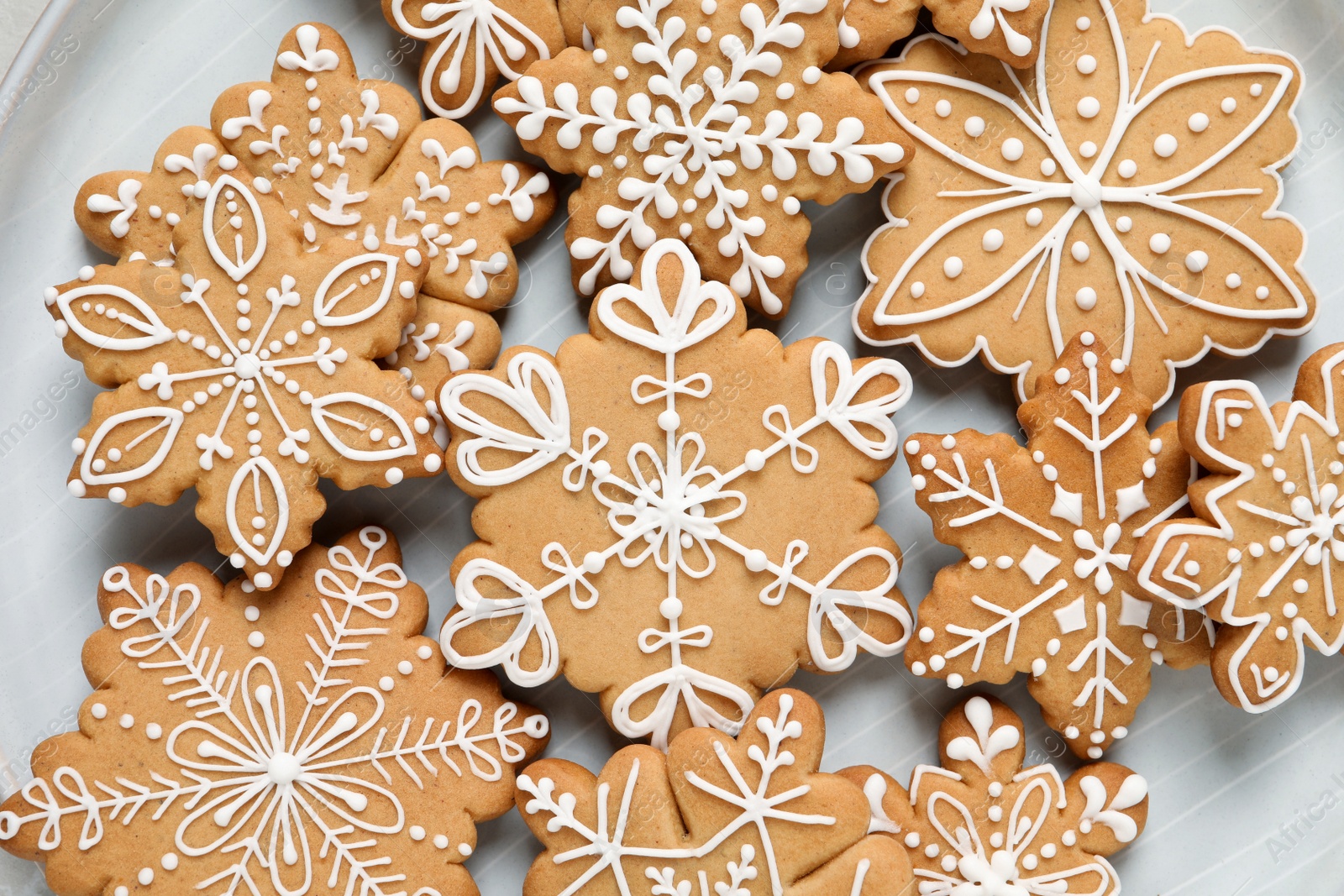 Photo of Tasty Christmas cookies on plate, flat lay