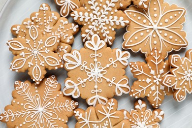 Photo of Tasty Christmas cookies on plate, flat lay