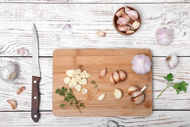 Photo of Flat lay composition with fresh garlic on wooden background