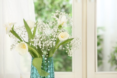 Beautiful fresh flowers near window indoors, closeup