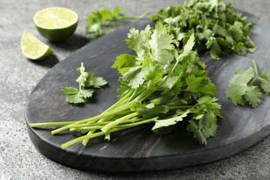 Photo of Fresh green cilantro on grey table, closeup