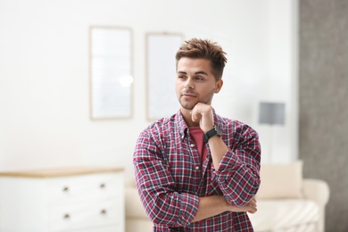 Portrait of handsome young man in room