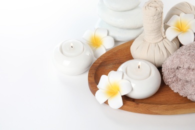 Beautiful spa composition with candles and flowers on white background