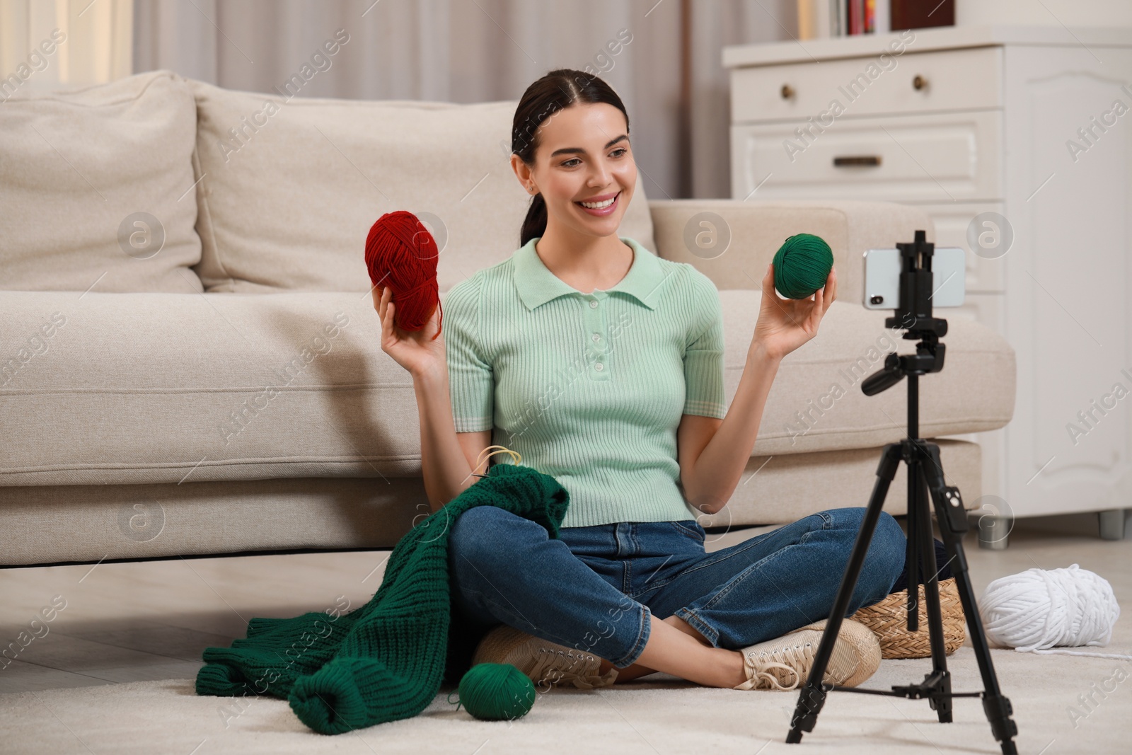 Photo of Teacher conducting online knitting course at home. Time for hobby