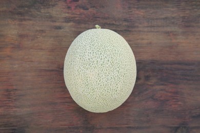 Photo of Whole ripe melon on wooden table, top view