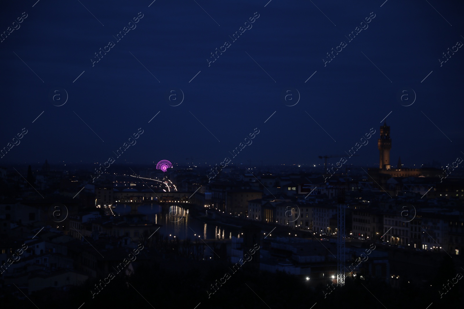 Photo of Picturesque view of city with buildings and bridge at night