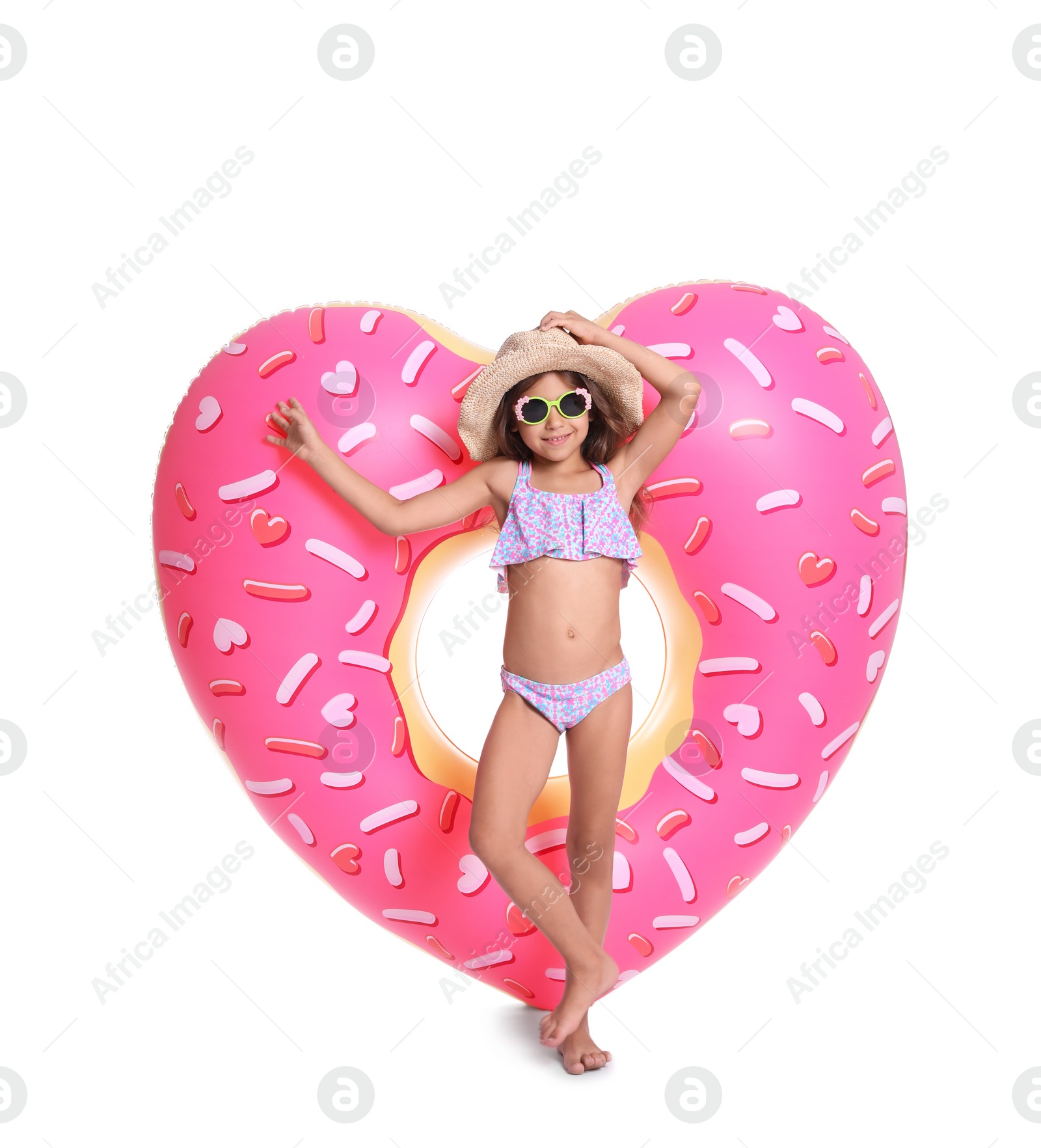 Photo of Cute little girl with inflatable heart on white background