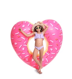 Photo of Cute little girl with inflatable heart on white background