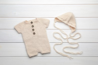 Stylish child's clothes on white wooden table, flat lay