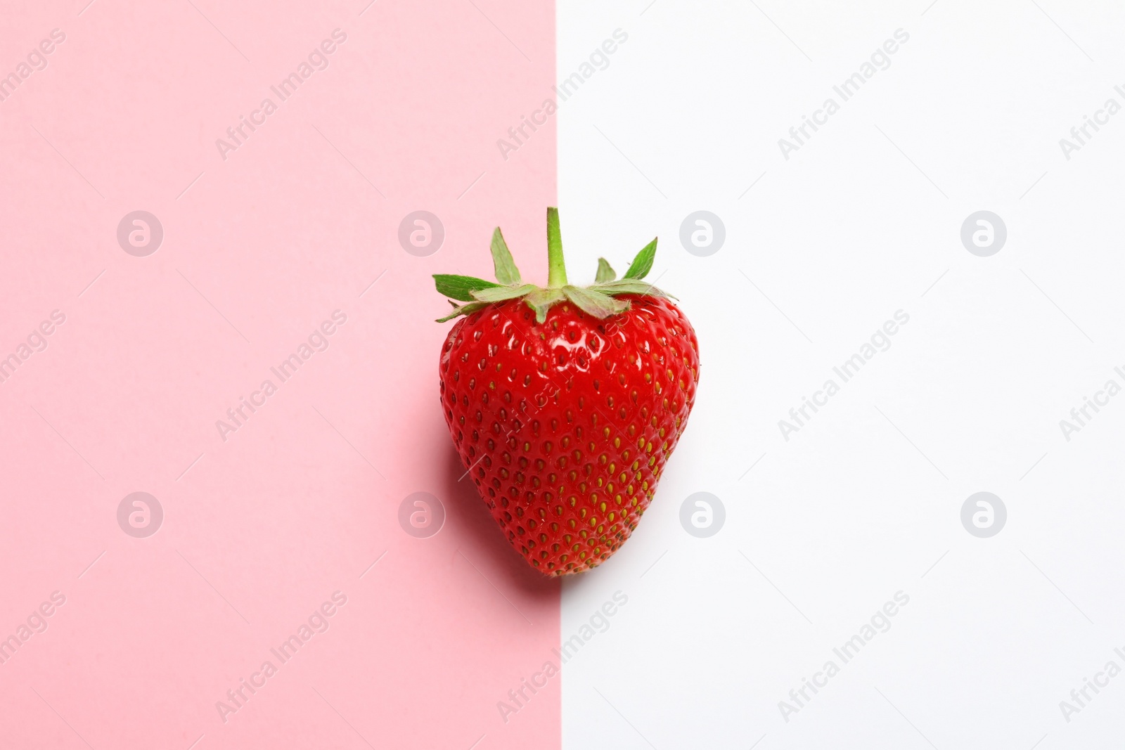 Photo of Ripe strawberry on color background, top view