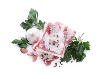 Photo of Pieces of pork fatback served with different ingredients isolated on white, top view