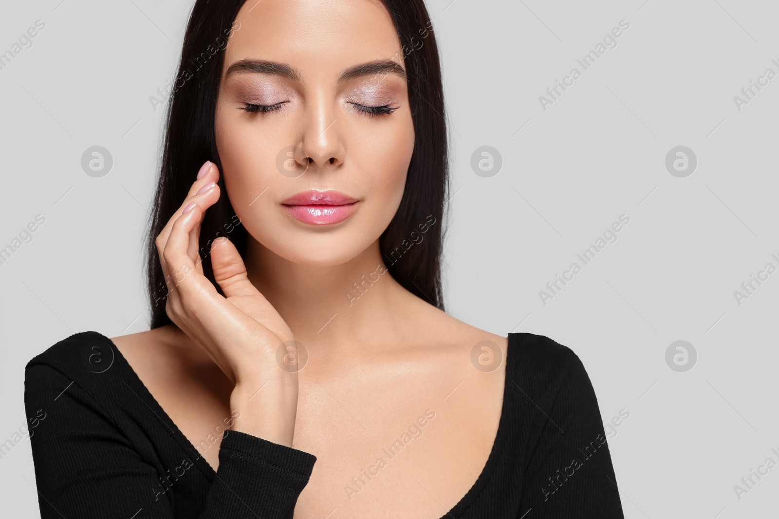 Photo of Portrait of beautiful young woman on light grey background