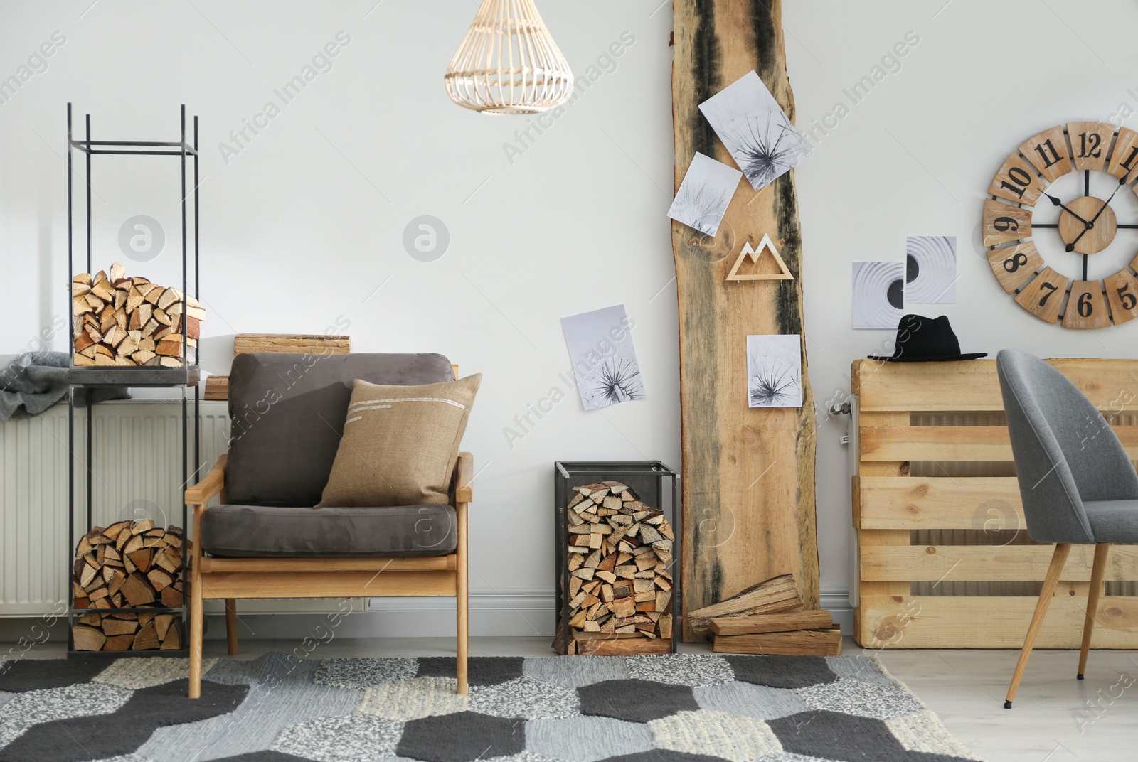 Photo of Stylish room interior with firewood as decorative element