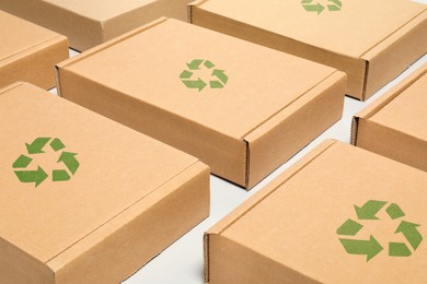 Image of Cardboard boxes with recycle sign stamps on white background