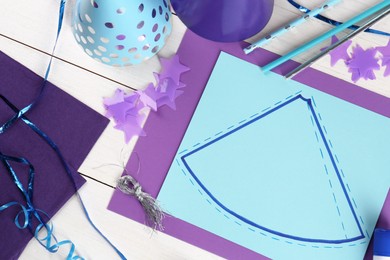 Photo of Flat lay composition with different materials to create party hats on white wooden table. Handmade decoration