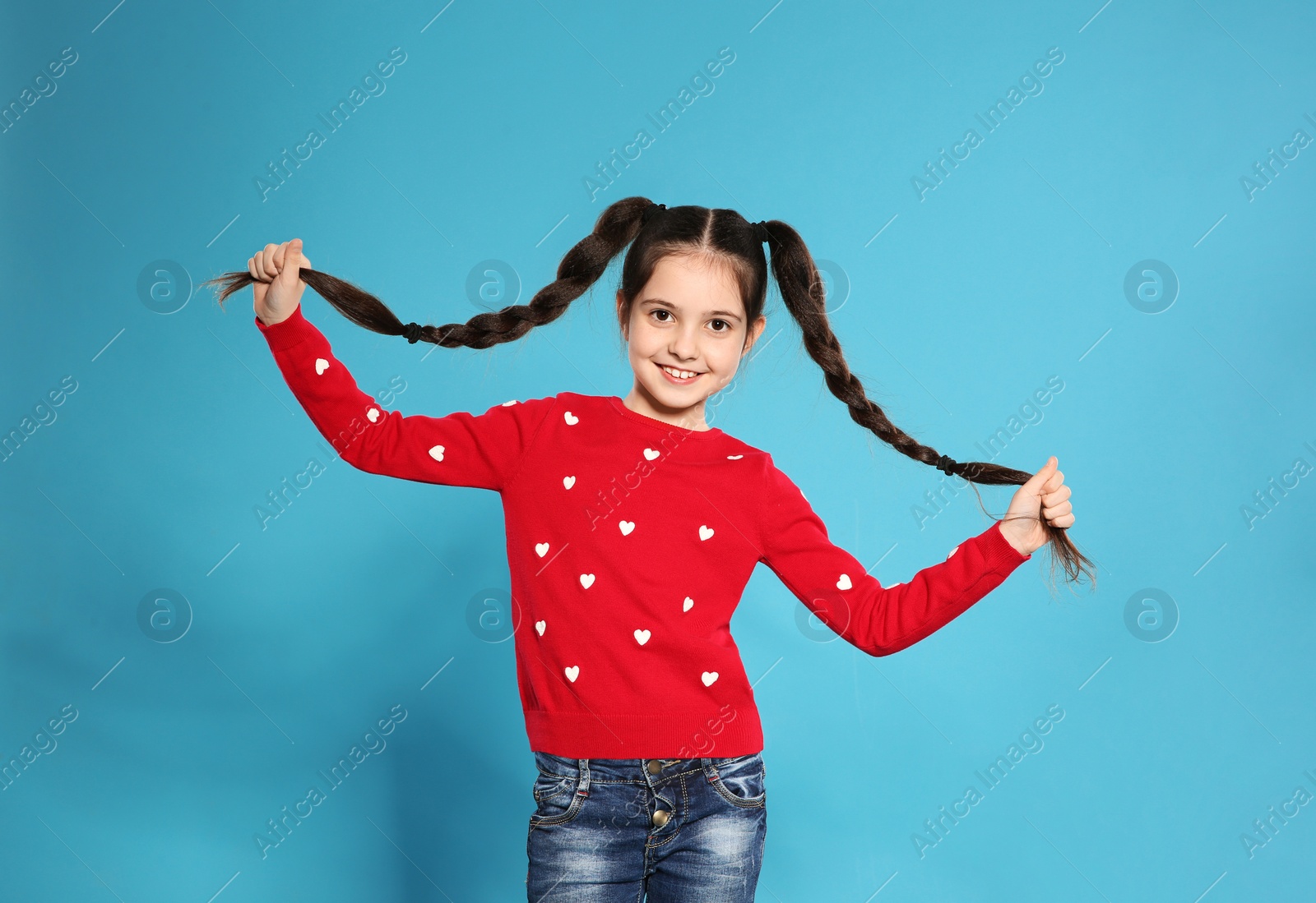 Photo of Portrait of little girl posing on color background